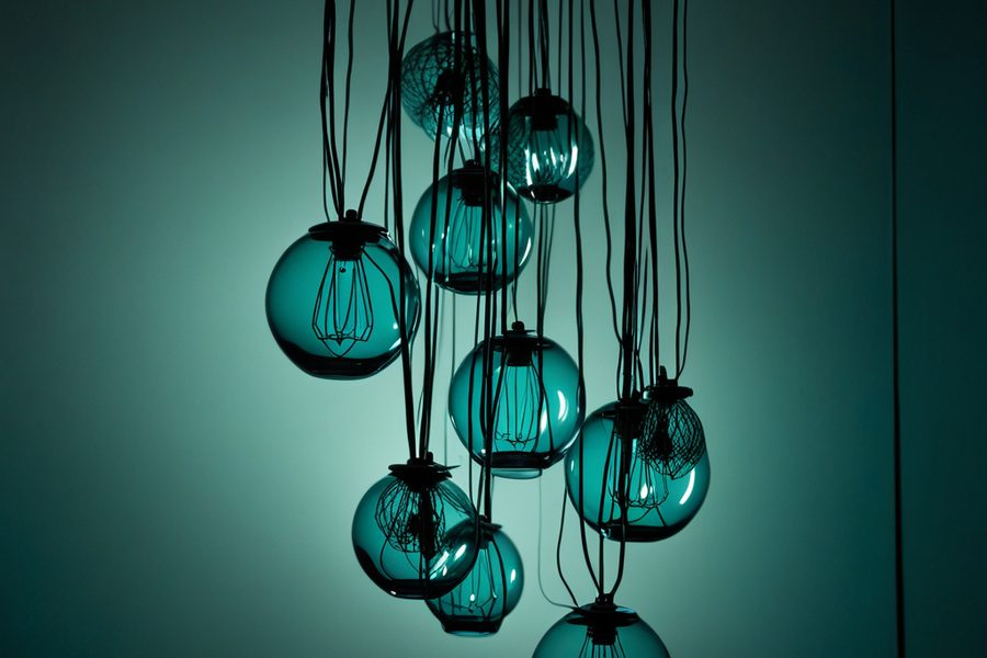 A network of glass nodes and threads suspended in darkness, illustrating model risk management